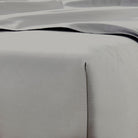 Close-up of gray bedding with a subtle texture