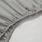 Close-up of a gray fitted sheet on a bed