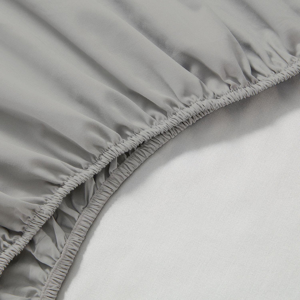 Close-up of a gray fitted sheet on a bed