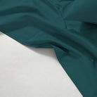 Teal fabric on a white background